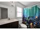 Bright bathroom featuring a modern vanity, toilet, and a colorful dolphin-themed shower curtain at 3281 Old Salem Rd, Conyers, GA 30013