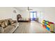 Bedroom with a couch, bed, ceiling fan, light walls and light gray wood-look flooring at 3281 Old Salem Rd, Conyers, GA 30013