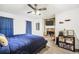 Comfortable bedroom with a stone fireplace, ceiling fan, and gray wood-look flooring at 3281 Old Salem Rd, Conyers, GA 30013