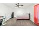 Neutral bedroom with a ceiling fan, light walls and light gray wood-look flooring at 3281 Old Salem Rd, Conyers, GA 30013