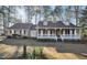 Charming home with a welcoming front porch and a well-manicured lawn surrounded by mature trees at 3281 Old Salem Rd, Conyers, GA 30013