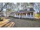 Inviting single-Gathering home featuring a classic design with a full, covered front porch and a neatly maintained yard at 3281 Old Salem Rd, Conyers, GA 30013