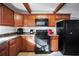 Practical kitchen featuring black appliances, wooden cabinets, and a built-in microwave at 3281 Old Salem Rd, Conyers, GA 30013