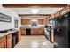 Functional kitchen featuring wood cabinetry, black appliances, and ample counter space at 3281 Old Salem Rd, Conyers, GA 30013
