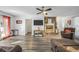 Open-concept living room featuring modern flooring, a stone fireplace, and large windows for abundant natural light at 3281 Old Salem Rd, Conyers, GA 30013