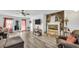 Open living room with a stone fireplace, hardwood floors, and sliding doors to the patio at 3281 Old Salem Rd, Conyers, GA 30013
