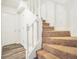 Carpeted stairs and white railing of stairway lead to the upper floor, with storage closets nearby at 3281 Old Salem Rd, Conyers, GA 30013