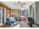 Inviting sunroom with a plush blue sofa, entertainment center, and plenty of natural light at 3281 Old Salem Rd, Conyers, GA 30013