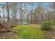 View of the backyard, shed, and surrounding wooded area at 845 James Path Ct, Lawrenceville, GA 30044