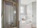 Cozy bathroom featuring a glass shower, tub, and white tile at 845 James Path Ct, Lawrenceville, GA 30044
