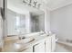 Bathroom features a double sink vanity with a large mirror and a separate shower at 845 James Path Ct, Lawrenceville, GA 30044