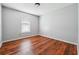 Bedroom features laminate flooring, light gray walls, and natural light at 845 James Path Ct, Lawrenceville, GA 30044