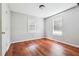 Bedroom features laminate flooring, light gray walls, and natural light at 845 James Path Ct, Lawrenceville, GA 30044