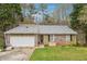 Charming one-story home featuring a brick facade and a spacious two-car garage at 845 James Path Ct, Lawrenceville, GA 30044