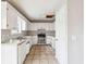 Functional kitchen featuring white cabinets, stainless steel appliances, and tile floor at 845 James Path Ct, Lawrenceville, GA 30044