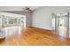 Open-concept living room with hardwood floors, fireplace, and a large window bay at 845 James Path Ct, Lawrenceville, GA 30044