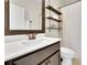 Bathroom with a white sink, bronze faucet and hardware, and an over-the-toilet shelf at 971 Thibideau Ct, Sandy Springs, GA 30328