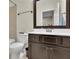 Well-lit bathroom featuring a dark vanity and a coordinating framed mirror at 971 Thibideau Ct, Sandy Springs, GA 30328