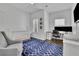 Bright bedroom featuring a crib, chair, desk area, and stylish blue geometric rug at 971 Thibideau Ct, Sandy Springs, GA 30328