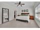Bedroom with a queen bed, a ceiling fan, carpet, and two windows for natural lighting at 971 Thibideau Ct, Sandy Springs, GA 30328