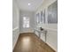 Elegant foyer featuring hardwood floors, a stylish table, and decorative wall art at 971 Thibideau Ct, Sandy Springs, GA 30328