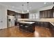 Spacious kitchen featuring dark wood cabinets, stainless steel appliances, and a center island at 971 Thibideau Ct, Sandy Springs, GA 30328