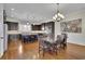 This open kitchen and dining area has dark wood cabinetry, granite counters, stainless steel appliances and wooden floors at 971 Thibideau Ct, Sandy Springs, GA 30328