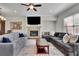 This open living area has hardwood floors, a fireplace, a large window, a gray couch and dining table at 971 Thibideau Ct, Sandy Springs, GA 30328