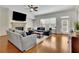 This open living area has hardwood floors, a fireplace, a large window and gray couches at 971 Thibideau Ct, Sandy Springs, GA 30328