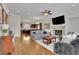 This open living area has hardwood floors, a fireplace, large windows, gray couches and a modern kitchen at 971 Thibideau Ct, Sandy Springs, GA 30328