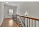Staircase landing with beautiful hardwood floors, a decorative railing, a window and fresh white paint at 971 Thibideau Ct, Sandy Springs, GA 30328