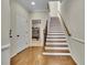 Staircase with hardwood steps and railing, leading to other areas of the home at 971 Thibideau Ct, Sandy Springs, GA 30328