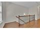 Staircase landing with beautiful hardwood floors, a decorative railing, a window and fresh white paint at 971 Thibideau Ct, Sandy Springs, GA 30328
