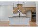 Stylish kitchen features an island, pendant lighting, stainless appliances, and sleek countertops at 2568 Silver Star Ne Dr, Marietta, GA 30066
