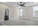 Bright main bedroom with plush carpeting, large windows, and a ceiling fan at 2568 Silver Star Ne Dr, Marietta, GA 30066