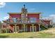 Backyard with a red house, stone chimney, deck, and covered porch at 270 Oak Ridge Rd, Covington, GA 30016