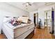 Bedroom with hardwood floors, bright window, ceiling fan, closet, and door, needs decluttering at 270 Oak Ridge Rd, Covington, GA 30016