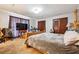 Bedroom featuring carpet, a large bed, a dresser with a TV, and a light fixture at 270 Oak Ridge Rd, Covington, GA 30016