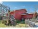 Exterior of a red house with a stone chimney, wooden deck, and staircase at 270 Oak Ridge Rd, Covington, GA 30016