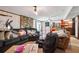 Cozy living room featuring a stone accent wall, ceiling fan, and adjacent kitchenette, needs decluttering at 270 Oak Ridge Rd, Covington, GA 30016
