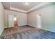 Spacious bedroom with plush carpeting, tray ceiling, and two doorways leading to other areas at 293 Depot Landing Rd, Auburn, GA 30011