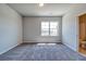 Bedroom with carpeted floors, neutral paint, and a bathroom entrance at 293 Depot Landing Rd, Auburn, GA 30011