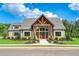 Beautiful clubhouse with stone and wood accents, lush landscaping, and a welcoming entrance at 293 Depot Landing Rd, Auburn, GA 30011