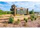 Rustic wooden entrance sign for Auburn Station with brick base, set amidst natural surroundings at 293 Depot Landing Rd, Auburn, GA 30011