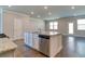 Open kitchen features a granite island with stainless steel appliances and wood floors at 293 Depot Landing Rd, Auburn, GA 30011