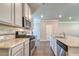 Well-equipped kitchen with stainless steel appliances, granite countertops, and tile backsplash at 293 Depot Landing Rd, Auburn, GA 30011