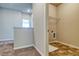 The laundry room has tile flooring, utility connections, and a wire shelf for storage at 293 Depot Landing Rd, Auburn, GA 30011
