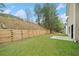 Well-maintained backyard with a tiered wooden retaining wall and lush lawn, perfect for outdoor enjoyment at 3920 Cain Mill Dr, Lithonia, GA 30038