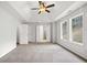 Spacious bedroom features a tray ceiling, ceiling fan, neutral paint, and plush carpeting at 3920 Cain Mill Dr, Lithonia, GA 30038
