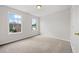 Cozy bedroom with carpet flooring, two windows, and neutral-colored walls at 3920 Cain Mill Dr, Lithonia, GA 30038